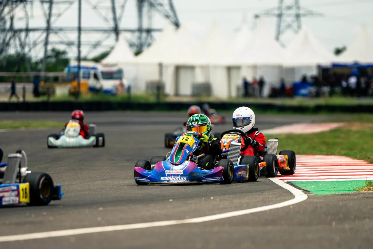 Vidyuth leads a pack of karts through a corner in kart number 12