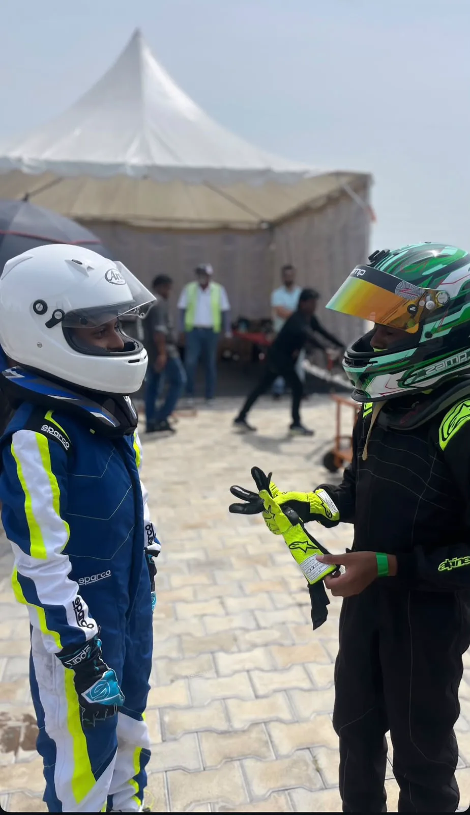 Talking gloves and setup with a fellow driver before a session