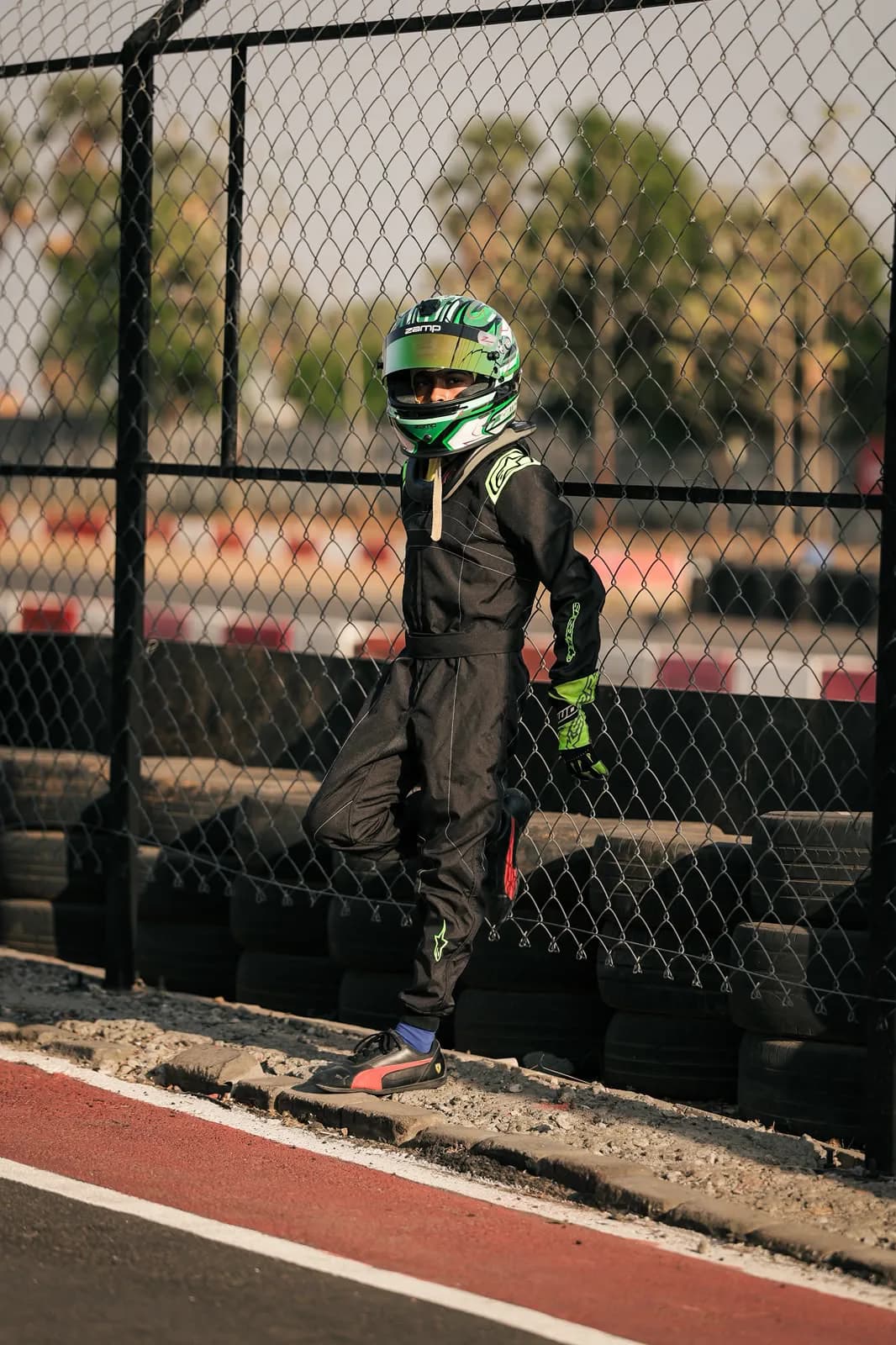 Suited up at the fence, helmet on, waiting for track time